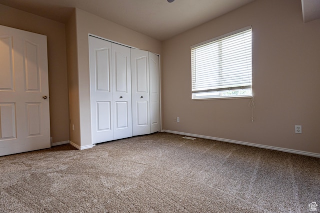 4902 W Pine Laurel Ln, West Jordan, UT 84081 - unfurnished bedroom featuring baseboards, carpet, a closet, and visible vents