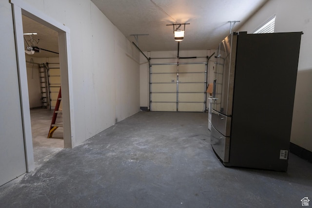 4902 W Pine Laurel Ln, West Jordan, UT 84081 - garage featuring freestanding refrigerator and a garage door opener