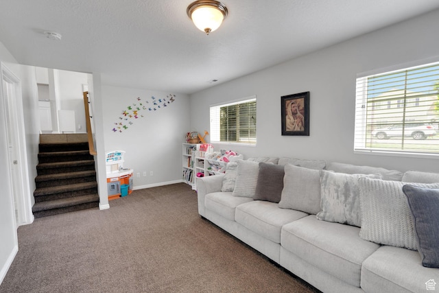 carpeted living room with stairs and baseboards