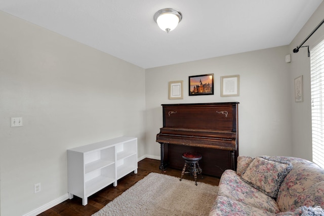 sitting room featuring baseboards and wood finished floors