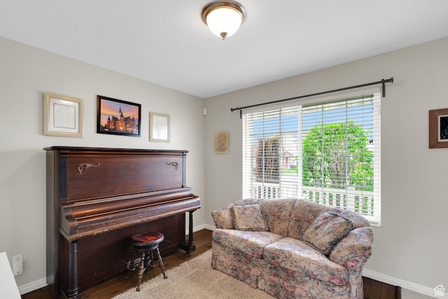 sitting room featuring baseboards and wood finished floors