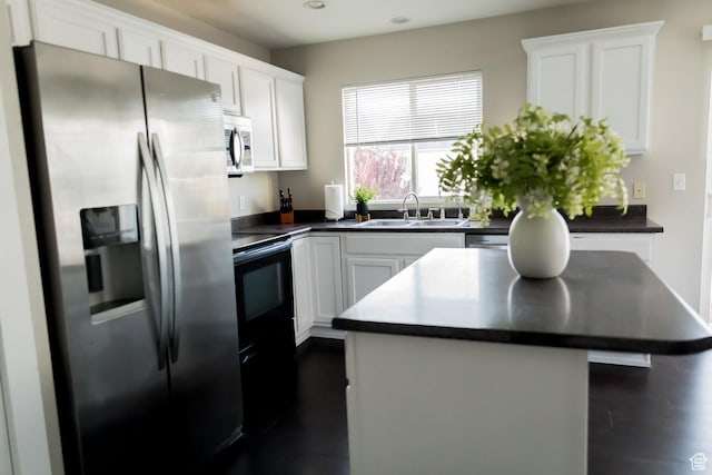 4866 W Spirit Lake Cir, Riverton, UT 84096 - kitchen with a sink, white cabinets, dark countertops, and stainless steel appliances