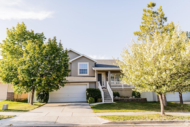 4866 W Spirit Lake Cir, Riverton, UT 84096 - view of front facade with a garage, stucco siding, stairway, a front yard, and concrete driveway