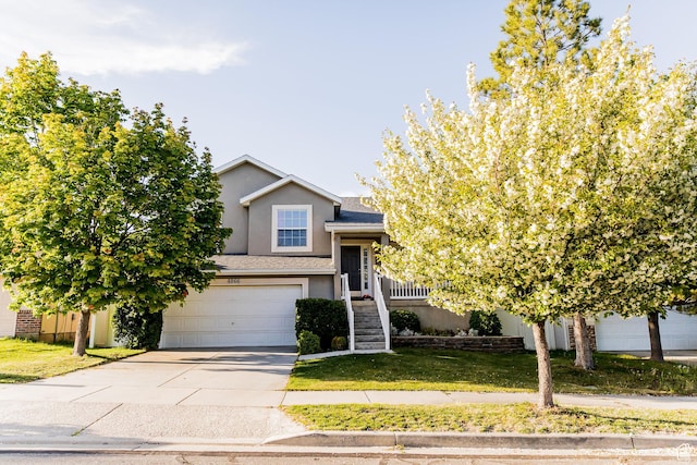 4866 W Spirit Lake Cir, Riverton, UT 84096 - view of front of home featuring an attached garage, stucco siding, concrete driveway, and a front yard