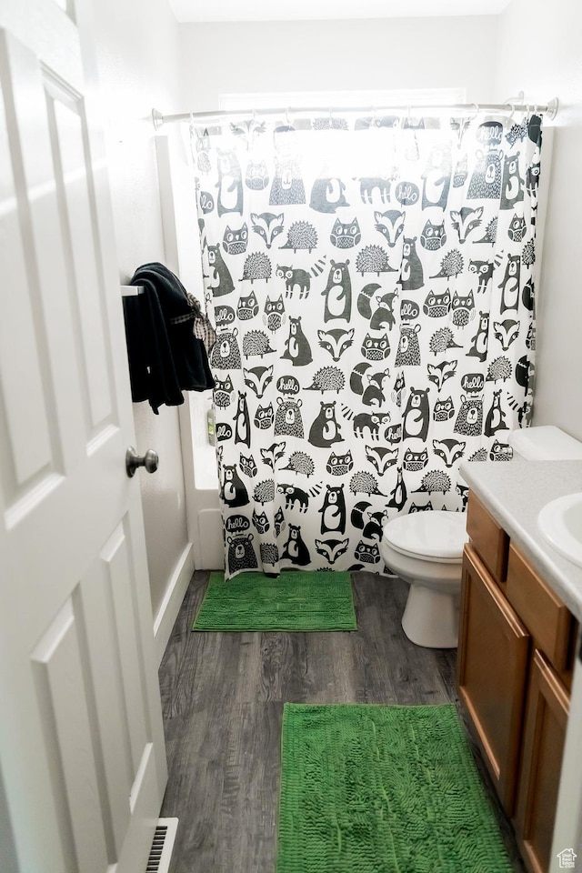 4866 W Spirit Lake Cir, Riverton, UT 84096 - bathroom featuring vanity, visible vents, wood finished floors, curtained shower, and toilet