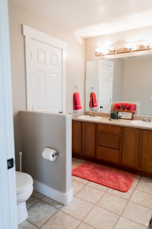 4866 W Spirit Lake Cir, Riverton, UT 84096 - bathroom with double vanity, a sink, tile patterned floors, and toilet