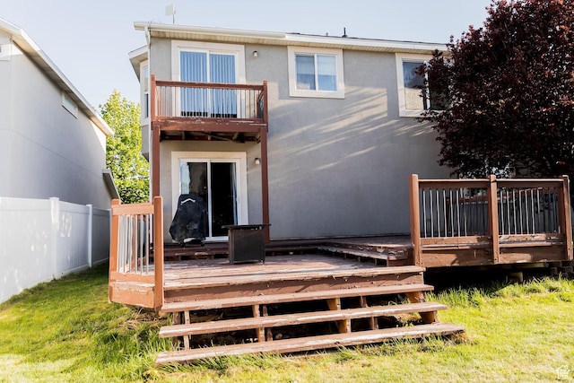 4866 W Spirit Lake Cir, Riverton, UT 84096 - rear view of property featuring stucco siding, fence, a balcony, and a wooden deck