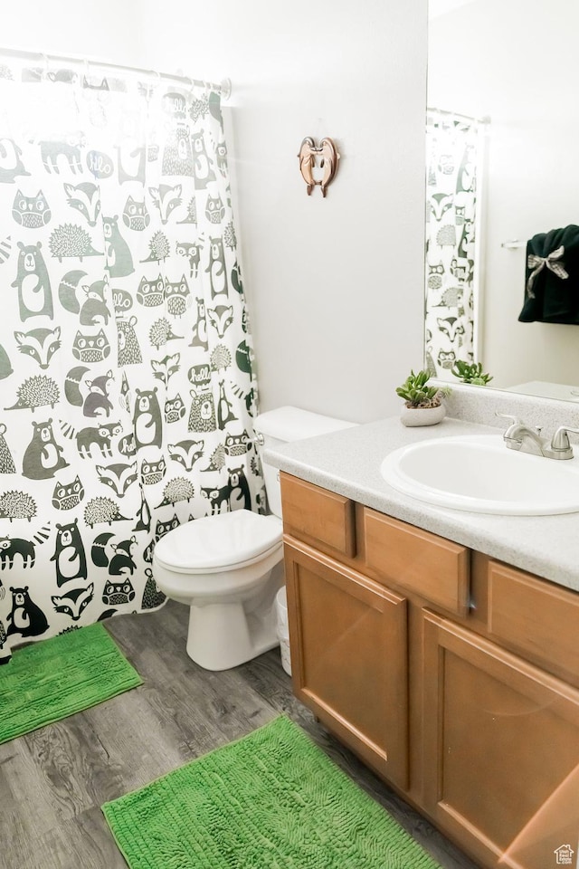 4866 W Spirit Lake Cir, Riverton, UT 84096 - full bath with vanity, wood finished floors, toilet, and a shower with curtain