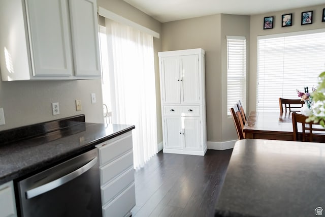 4866 W Spirit Lake Cir, Riverton, UT 84096 - kitchen with dark wood-style flooring, dark countertops, dishwasher, baseboards, and white cabinets