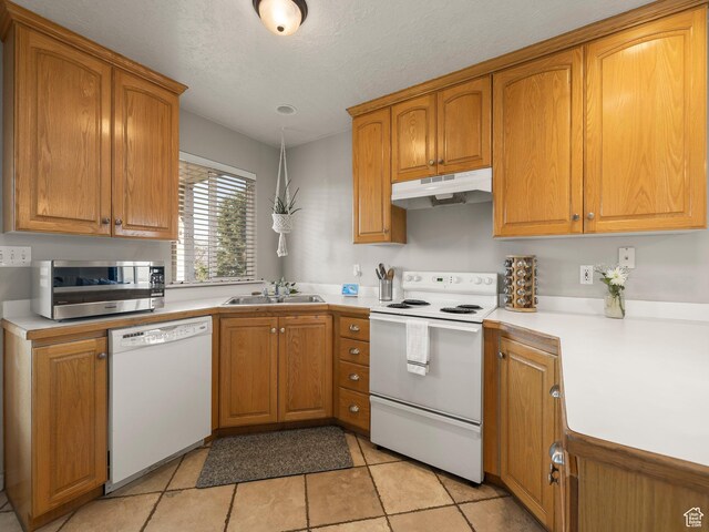 426 E 400 S, American Fork, UT 84003 - kitchen featuring brown cabinets, a sink, white appliances, light countertops, and under cabinet range hood