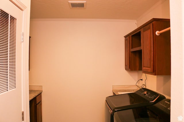 610 S Trout Dr, Manila, UT 84046 - laundry area featuring visible vents, crown molding, cabinet space, washer and dryer, and a heating unit