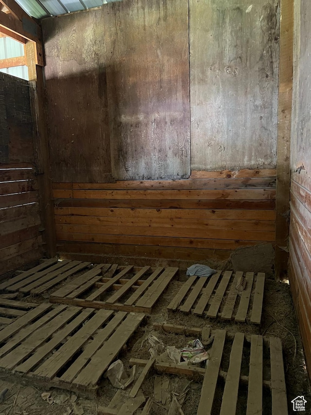 misc room featuring a relaxing sauna and wood walls