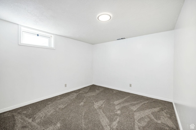 518 E Wendy Way S, Tremonton, UT 84337 - spare room featuring baseboards, dark colored carpet, and visible vents