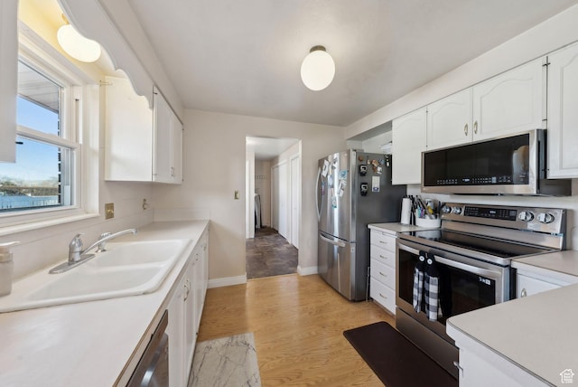 518 E Wendy Way S, Tremonton, UT 84337 - kitchen with white cabinets, stainless steel appliances, a sink, and light countertops