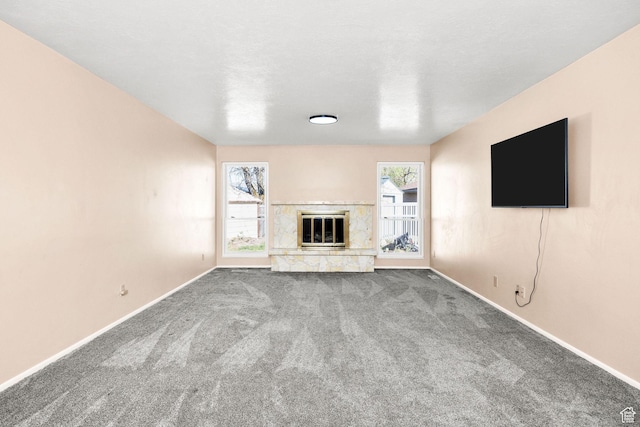 518 E Wendy Way S, Tremonton, UT 84337 - unfurnished living room with baseboards, carpet, and a glass covered fireplace