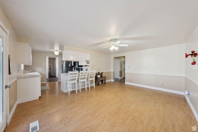 518 E Wendy Way S, Tremonton, UT 84337 - living room featuring a ceiling fan, baseboards, visible vents, and light wood-style flooring