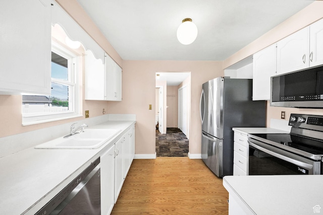518 E Wendy Way S, Tremonton, UT 84337 - kitchen with appliances with stainless steel finishes, a sink, light countertops, light wood finished floors, and white cabinetry