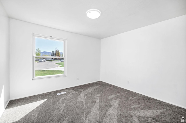 518 E Wendy Way S, Tremonton, UT 84337 - unfurnished room featuring visible vents, baseboards, and dark colored carpet