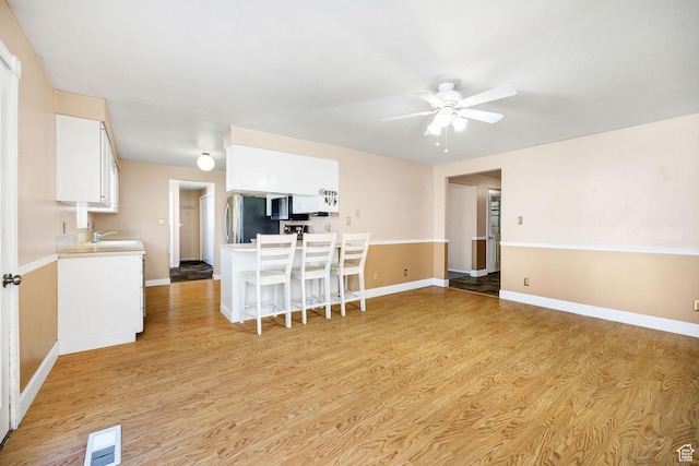 518 E Wendy Way S, Tremonton, UT 84337 - living area featuring baseboards, a ceiling fan, light wood-type flooring, and visible vents