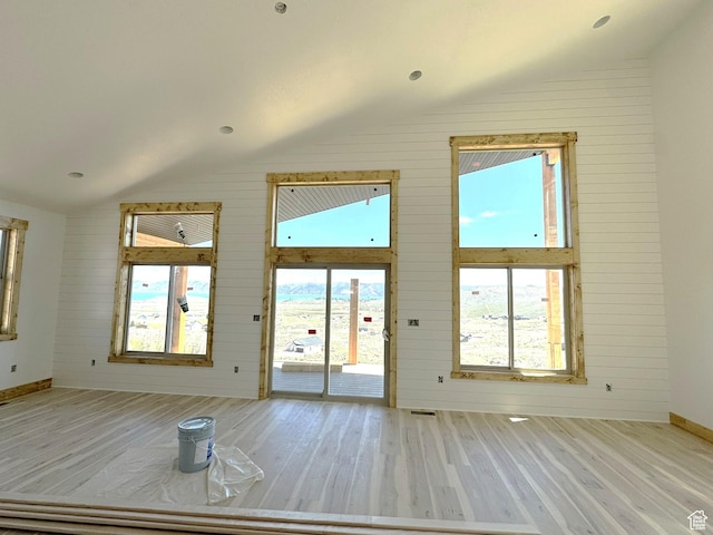 3042 S Chukar Dr, Garden City, UT 84028 - entryway featuring wood finished floors, baseboards, lofted ceiling, and a wealth of natural light