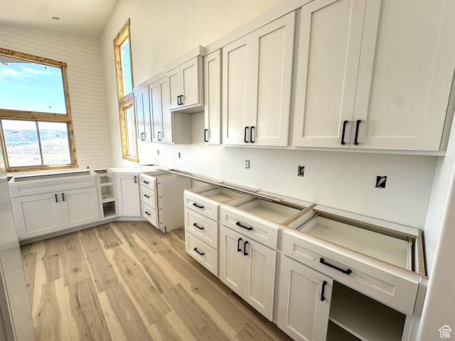 3042 S Chukar Dr, Garden City, UT 84028 - kitchen with light wood-style flooring and white cabinets