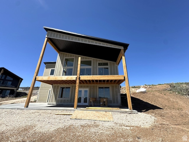 3042 S Chukar Dr, Garden City, UT 84028 - back of property featuring board and batten siding, a patio area, and french doors