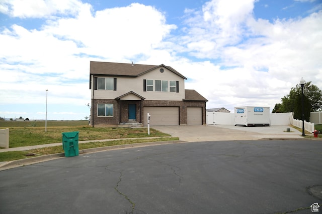 3596 W 2610 S, Syracuse, UT 84075 - view of front of house with driveway, fence, a garage, and brick siding