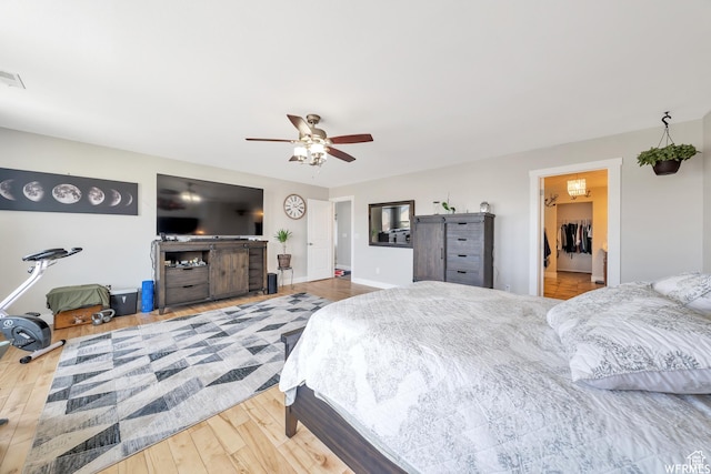 3596 W 2610 S, Syracuse, UT 84075 - bedroom with wood finished floors, ceiling fan, a spacious closet, and baseboards