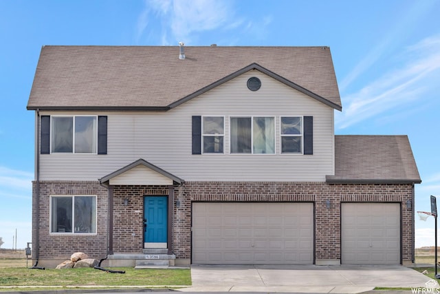 view of front of property with concrete driveway, brick siding, roof with shingles, and a garage