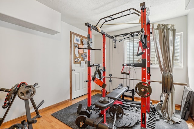 8564 S Laurel Oak Dr W, West Jordan, UT 84088 - workout room featuring wood finished floors, a textured ceiling, and baseboards