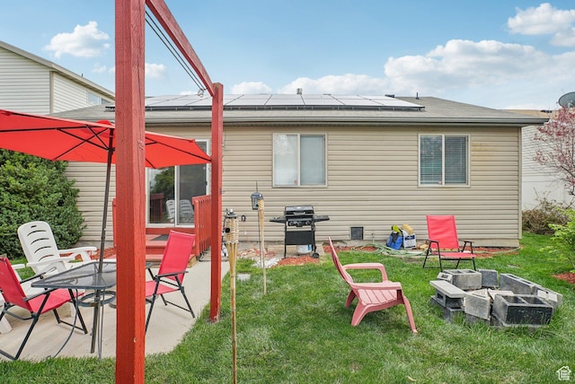 8564 S Laurel Oak Dr W, West Jordan, UT 84088 - back of house with an outdoor fire pit, a yard, solar panels, and a patio