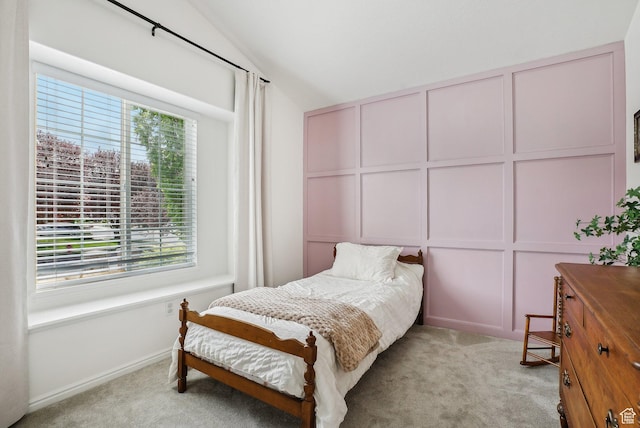 bedroom with multiple windows, light colored carpet, and vaulted ceiling