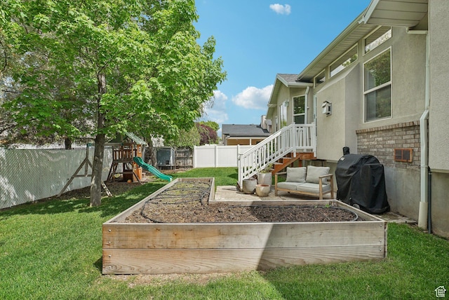 view of yard with a garden and a playground