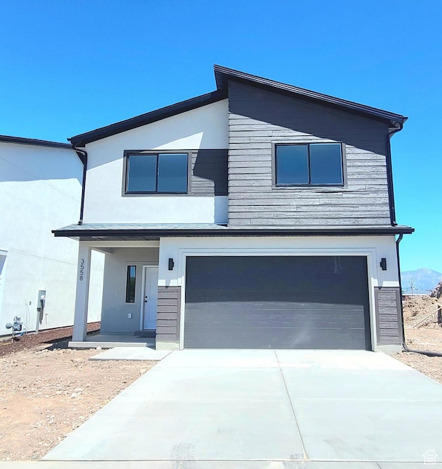 3558 W 4835 S Unit 17, Roy, UT 84067 - contemporary home featuring a garage, stucco siding, and driveway