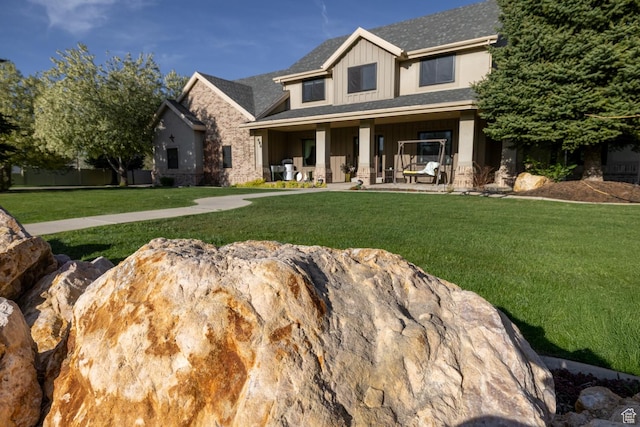 486 N 3500 W, Vernal, UT 84078 - craftsman house featuring a shingled roof, covered porch, board and batten siding, and a front lawn