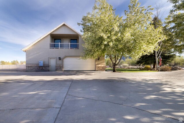 486 N 3500 W, Vernal, UT 84078 - view of property exterior with a garage, stucco siding, a balcony, and concrete driveway