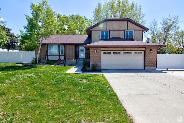 split level home featuring driveway, a front yard, a gate, brick siding, and fence