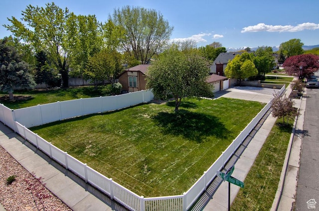 view of yard featuring fence private yard and a garage