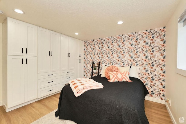 bedroom featuring recessed lighting, baseboards, wallpapered walls, and light wood-style flooring