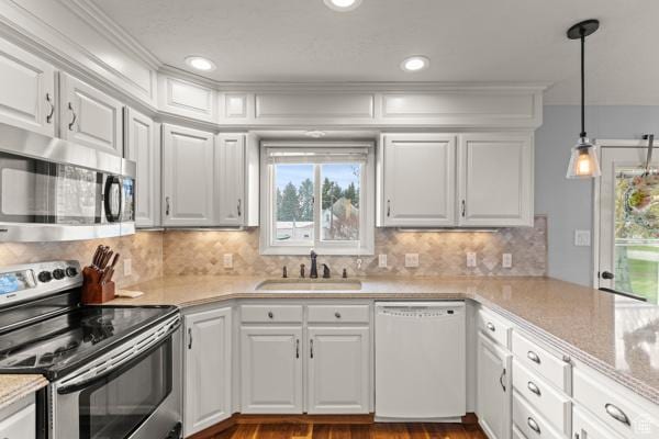 kitchen featuring a sink, light countertops, white cabinets, and stainless steel appliances