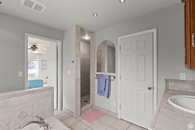 ensuite bathroom with a tile shower, tile patterned floors, a ceiling fan, ensuite bathroom, and visible vents