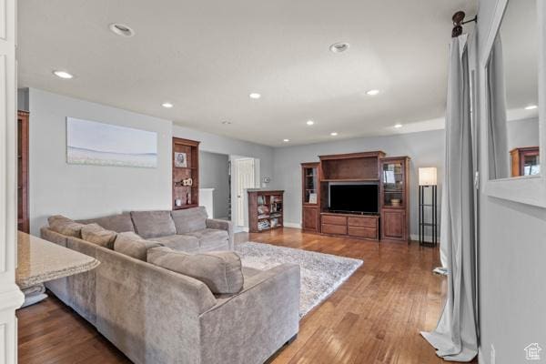 living area with recessed lighting and wood finished floors