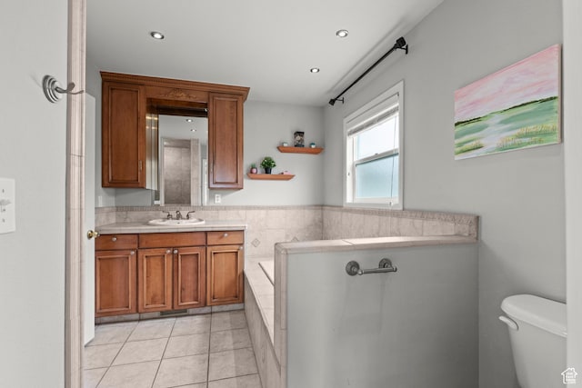 bathroom with tiled bath, vanity, toilet, tile patterned floors, and recessed lighting