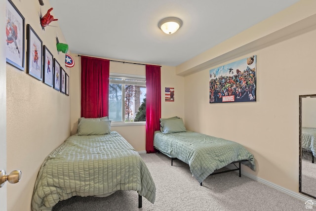 bedroom with carpet floors and baseboards