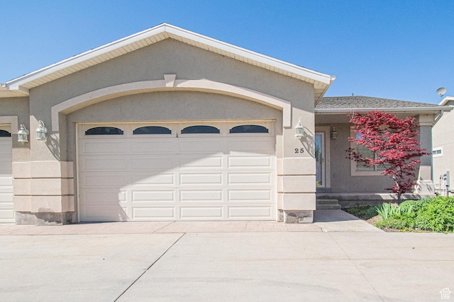 25 Clubhouse Dr, Stansbury Park, UT 84074 - view of front facade with a garage, stucco siding, and concrete driveway