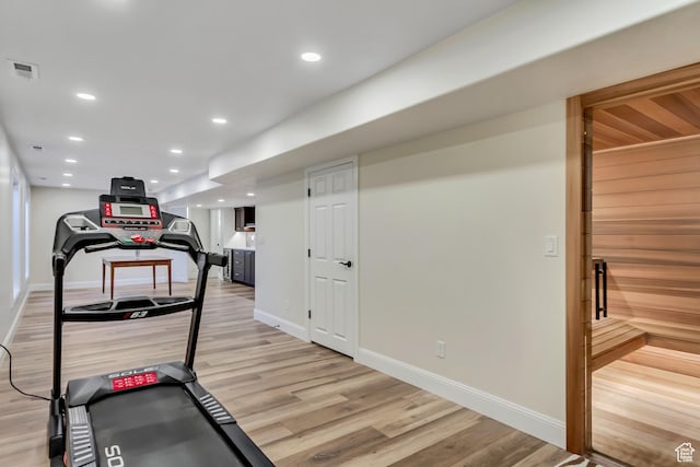 exercise area with recessed lighting, baseboards, light wood-type flooring, and visible vents
