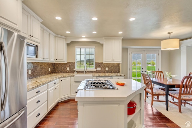 kitchen featuring appliances with stainless steel finishes, a sink, dark wood finished floors, french doors, and recessed lighting