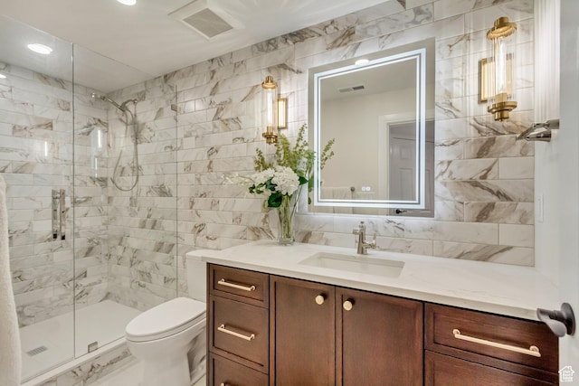 bathroom with tile walls, visible vents, a shower stall, and marble finish floor
