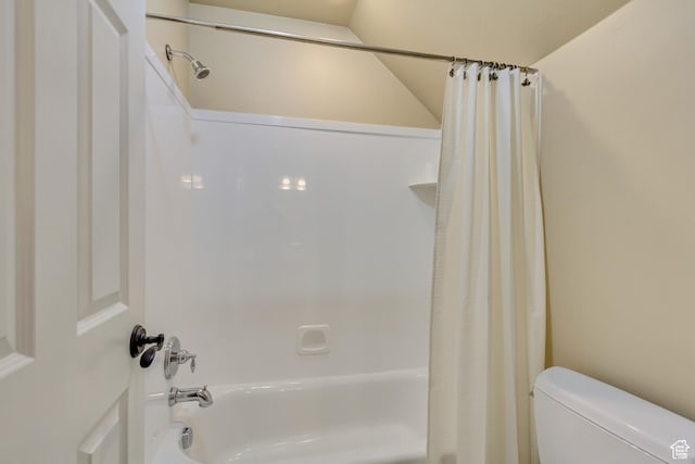 bathroom featuring shower / bath combination with curtain and toilet