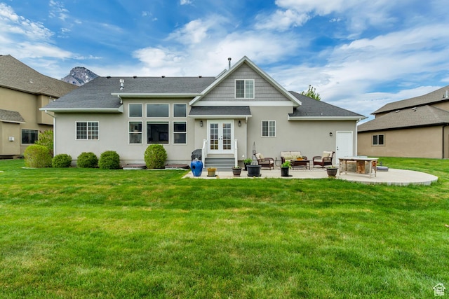 rear view of property with an outdoor living space with a fire pit, stucco siding, french doors, a patio area, and entry steps